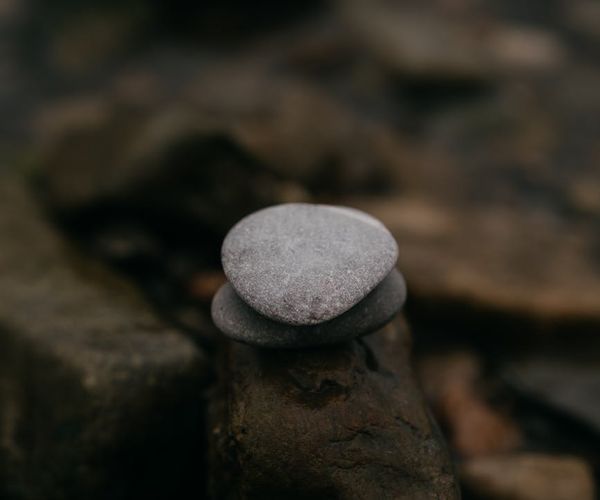 A perfectly balanced stack of stones on a calm surface.