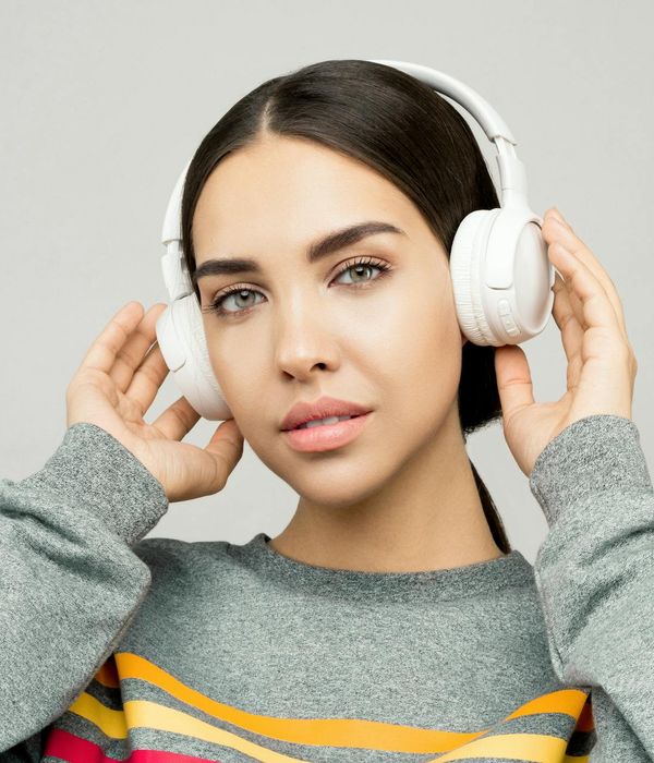 Woman looking calmly into the distance with a relaxed expression.